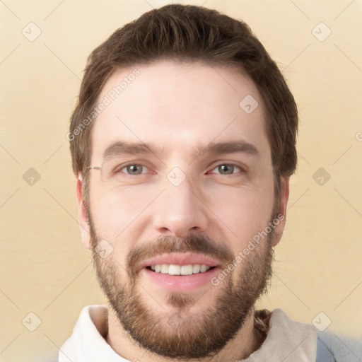 Joyful white young-adult male with short  brown hair and grey eyes