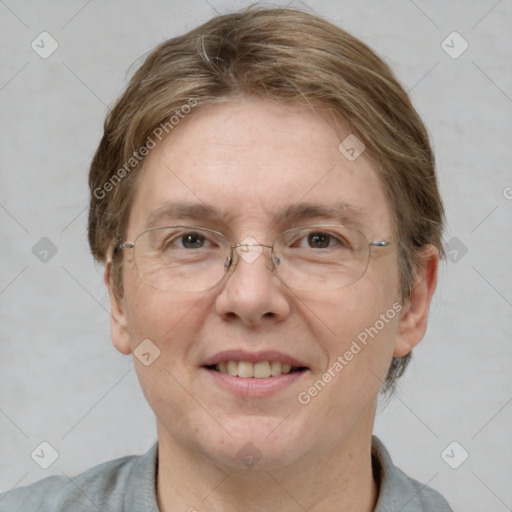 Joyful white adult female with short  brown hair and blue eyes