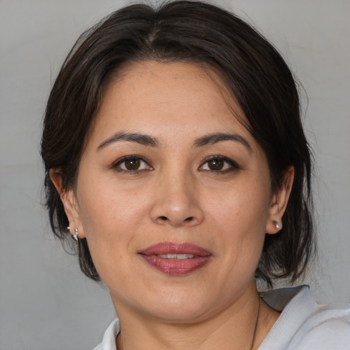 Joyful white adult female with medium  brown hair and brown eyes