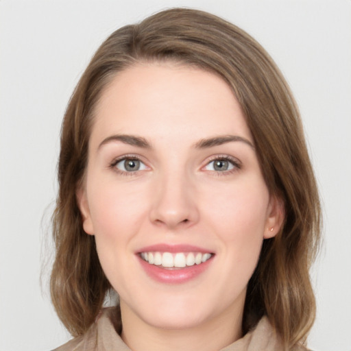 Joyful white young-adult female with medium  brown hair and green eyes