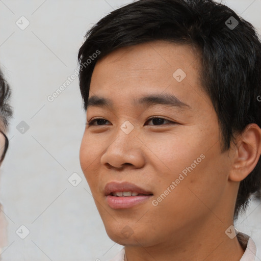 Joyful asian young-adult male with short  black hair and brown eyes