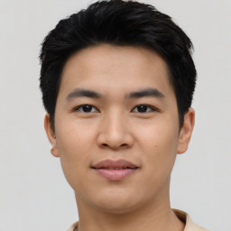 Joyful asian young-adult male with short  black hair and brown eyes