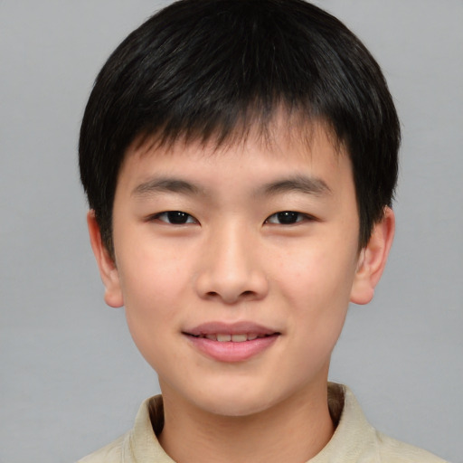 Joyful asian child male with short  brown hair and brown eyes