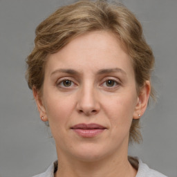 Joyful white adult female with medium  brown hair and grey eyes