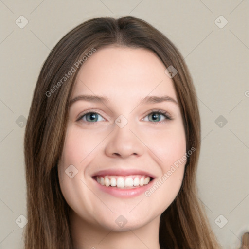 Joyful white young-adult female with long  brown hair and blue eyes