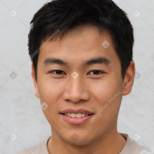 Joyful asian young-adult male with short  brown hair and brown eyes