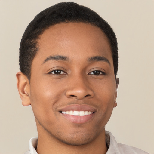 Joyful black young-adult male with short  brown hair and brown eyes