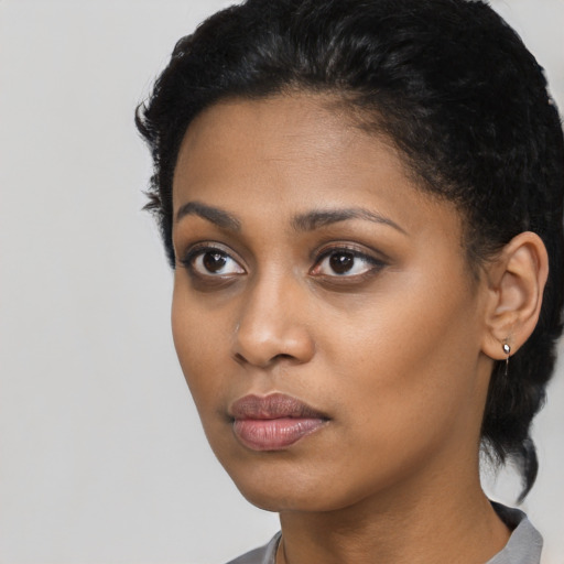 Neutral black young-adult female with short  black hair and brown eyes