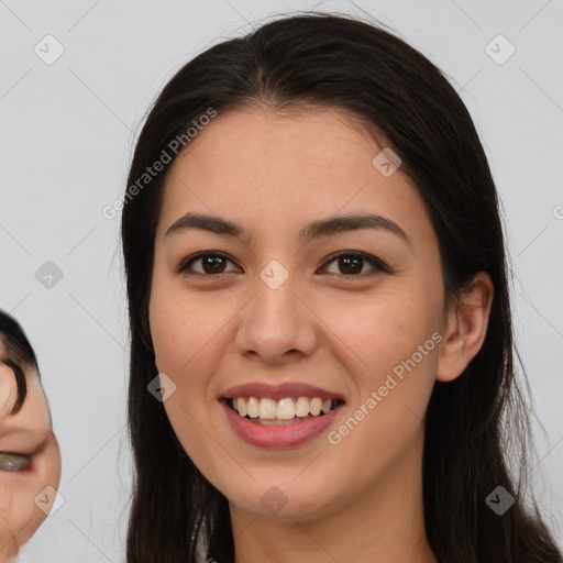 Joyful asian young-adult female with long  brown hair and brown eyes