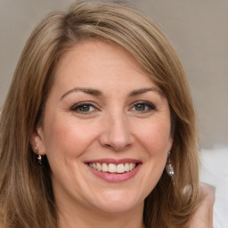 Joyful white adult female with long  brown hair and brown eyes