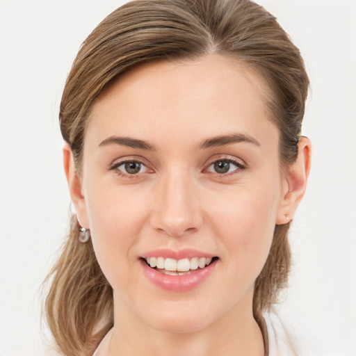 Joyful white young-adult female with long  brown hair and blue eyes