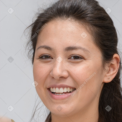 Joyful white young-adult female with long  brown hair and brown eyes