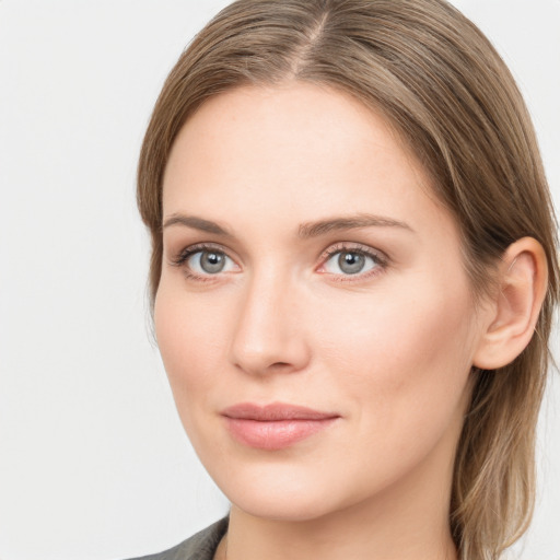 Joyful white young-adult female with long  brown hair and blue eyes