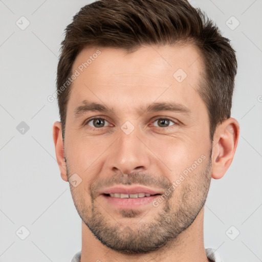 Joyful white young-adult male with short  brown hair and brown eyes