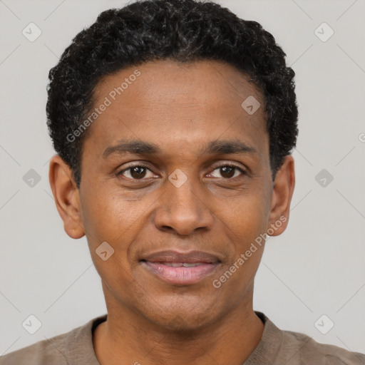 Joyful black adult male with short  black hair and brown eyes