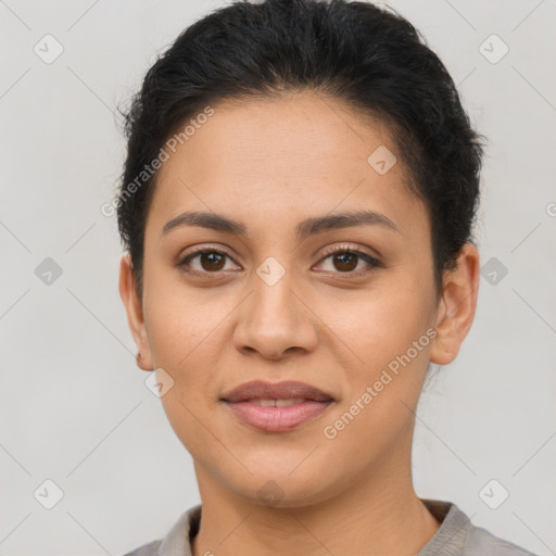 Joyful latino young-adult female with short  brown hair and brown eyes