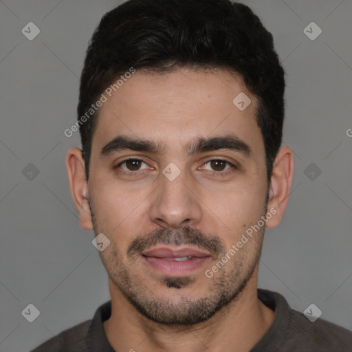 Joyful white young-adult male with short  black hair and brown eyes