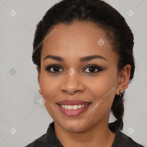 Joyful black young-adult female with medium  black hair and brown eyes