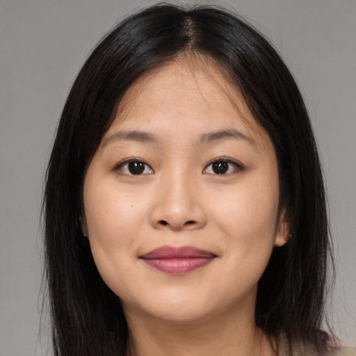 Joyful asian young-adult female with long  brown hair and brown eyes