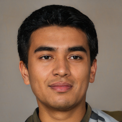Joyful latino young-adult male with short  black hair and brown eyes