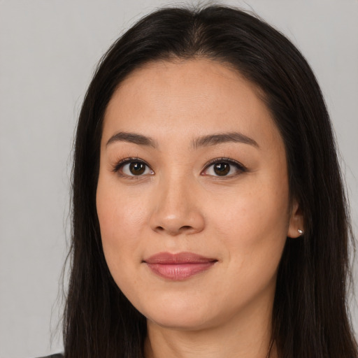 Joyful asian young-adult female with long  brown hair and brown eyes