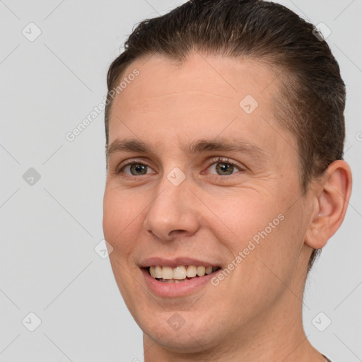 Joyful white adult male with short  brown hair and brown eyes