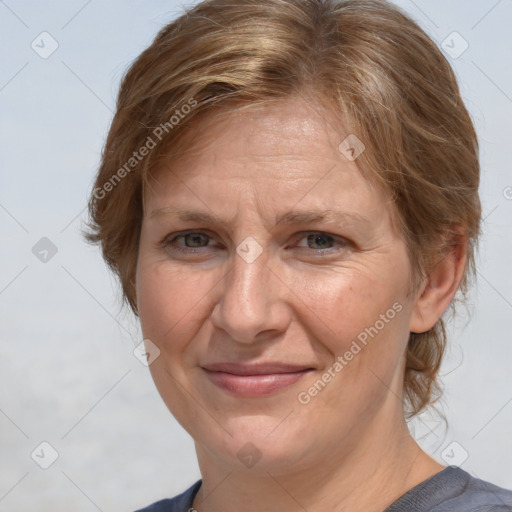 Joyful white adult female with medium  brown hair and grey eyes