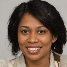 Joyful black young-adult female with medium  brown hair and brown eyes