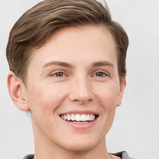 Joyful white young-adult female with short  brown hair and grey eyes