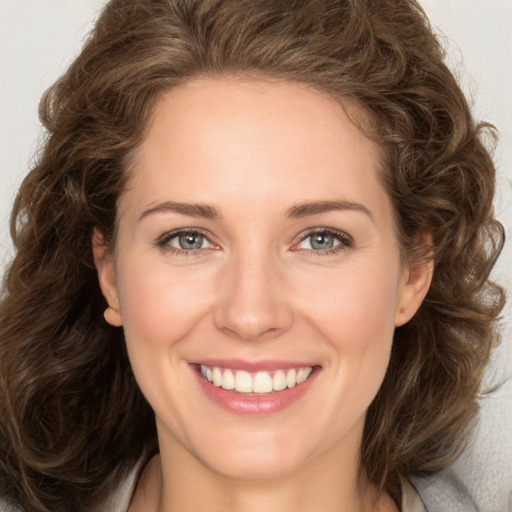 Joyful white young-adult female with long  brown hair and green eyes