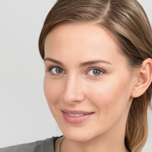 Joyful white young-adult female with medium  brown hair and grey eyes