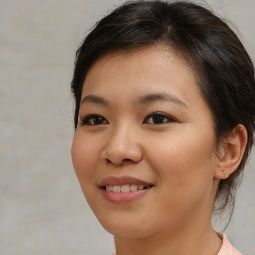 Joyful asian young-adult female with medium  brown hair and brown eyes