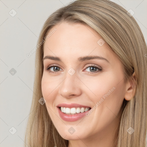 Joyful white young-adult female with long  brown hair and grey eyes