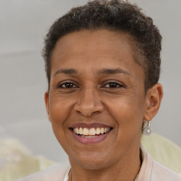 Joyful black adult female with short  brown hair and brown eyes