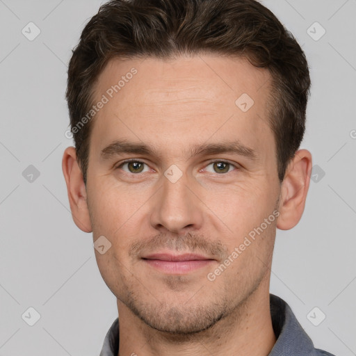 Joyful white young-adult male with short  brown hair and grey eyes