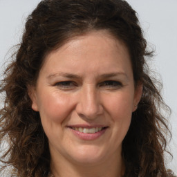 Joyful white adult female with long  brown hair and brown eyes