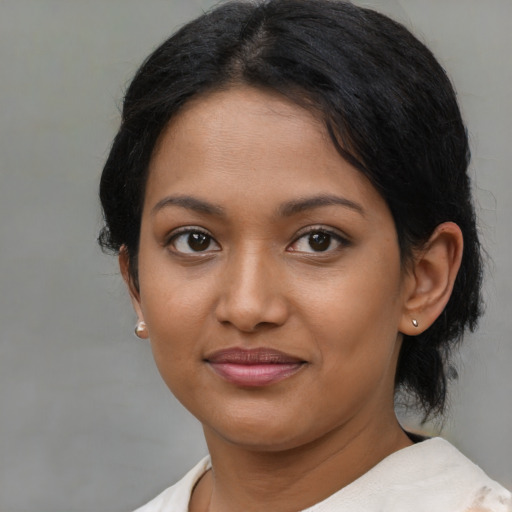 Joyful asian young-adult female with medium  brown hair and brown eyes