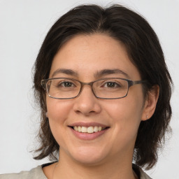 Joyful white adult female with medium  brown hair and brown eyes