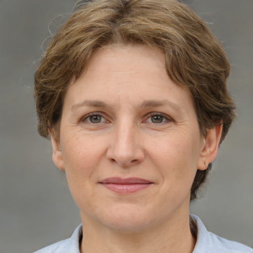 Joyful white adult female with short  brown hair and grey eyes