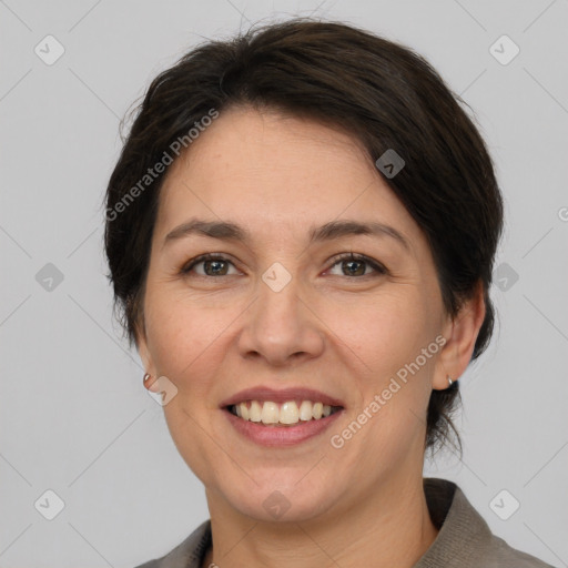 Joyful white adult female with medium  brown hair and brown eyes