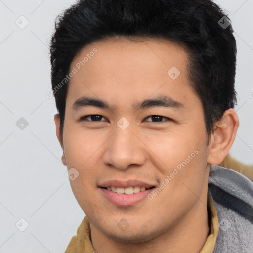 Joyful asian young-adult male with short  brown hair and brown eyes