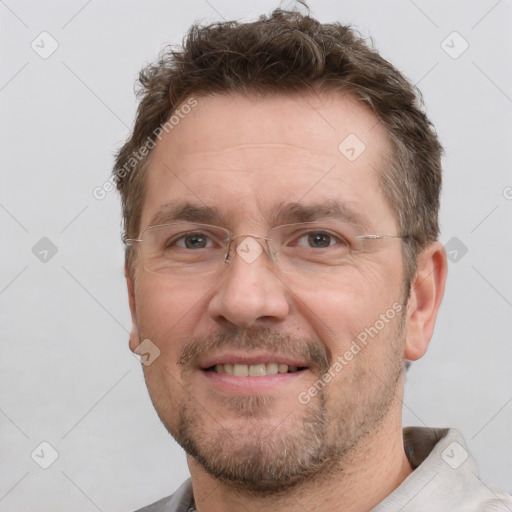 Joyful white adult male with short  brown hair and brown eyes