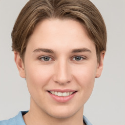 Joyful white young-adult female with short  brown hair and grey eyes