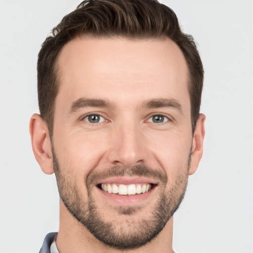 Joyful white young-adult male with short  brown hair and brown eyes