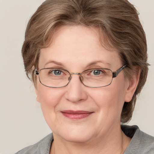 Joyful white adult female with medium  brown hair and grey eyes