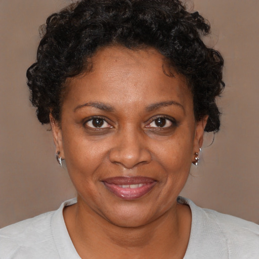 Joyful black adult female with short  brown hair and brown eyes