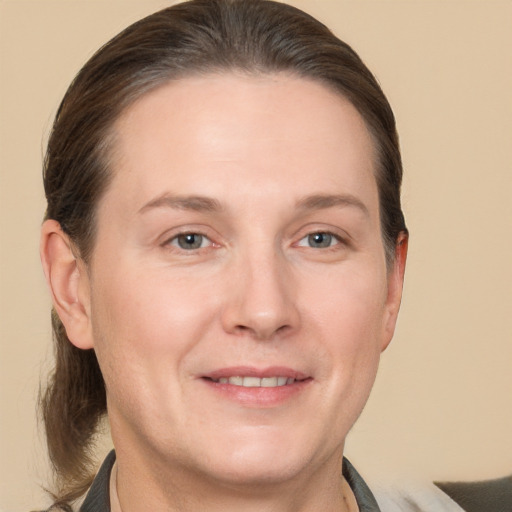 Joyful white adult female with short  brown hair and grey eyes