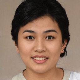 Joyful asian young-adult female with medium  black hair and brown eyes