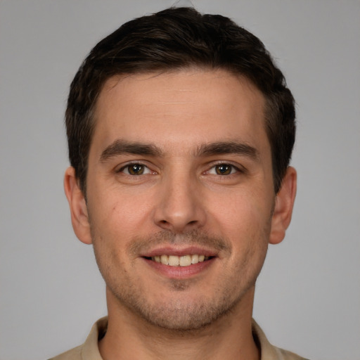 Joyful white young-adult male with short  brown hair and brown eyes