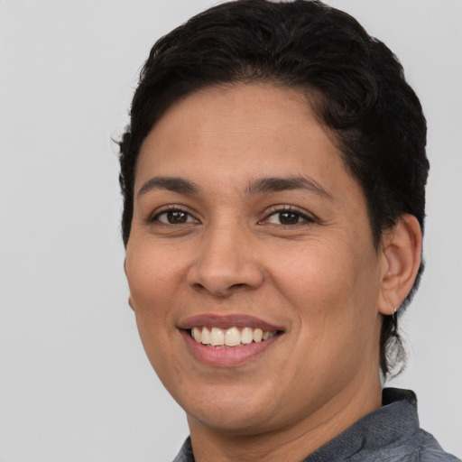 Joyful latino young-adult female with short  brown hair and brown eyes
